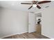 Bright, spacious bedroom featuring wood-look floors and a view into the kitchen at 18406 Sterling Silver Cir, Lutz, FL 33549