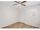 Bedroom features a ceiling fan, wood-look floors, and a closet, offering a comfortable retreat at 18406 Sterling Silver Cir, Lutz, FL 33549
