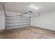 Spacious single-car garage featuring a light gray door, concrete floor, and overhead lighting at 18406 Sterling Silver Cir, Lutz, FL 33549