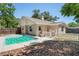 Backyard featuring a private pool, fenced for safety and surrounded by trees at 18406 Sterling Silver Cir, Lutz, FL 33549