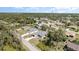 Aerial view of a home nestled among lush greenery and other neighborhood houses at 2202 Yalta Ter, North Port, FL 34286