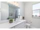 Well-lit bathroom featuring white cabinets, modern fixtures, and a large vanity mirror at 2202 Yalta Ter, North Port, FL 34286