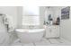 Bright bathroom features a freestanding tub, marble surround, and vanity at 2202 Yalta Ter, North Port, FL 34286