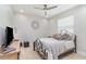 Bright bedroom with a wrought iron bed, modern ceiling fan, and a decorative wall medallion at 2202 Yalta Ter, North Port, FL 34286
