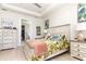 Comfortable bedroom with walk-in closet, light wood floors and a stylish decor at 2202 Yalta Ter, North Port, FL 34286