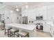 Modern kitchen with white cabinetry, stainless steel appliances, and a large center island at 2202 Yalta Ter, North Port, FL 34286