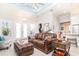Bright living room featuring a leather sofa, modern lighting, and access to the outdoor area at 2202 Yalta Ter, North Port, FL 34286