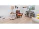 Bright living room featuring a colorful wingback chair, hardwood floors, and a table with chairs at 2202 Yalta Ter, North Port, FL 34286