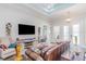 Comfortable living room with entertainment center, leather sofa, and open layout at 2202 Yalta Ter, North Port, FL 34286
