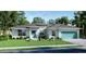 Charming single-story home boasts a light blue exterior, well-manicured lawn, and an attached two-car garage at 24276 Peppercorn Rd, Punta Gorda, FL 33955