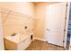 Utility sink and storage rack in the laundry area at 24276 Peppercorn Rd, Punta Gorda, FL 33955