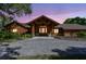 Stunning single-story home with a wooden facade, symmetrical design and beautiful stone accents at 27547 Miller Rd, Dade City, FL 33525