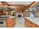 Bright kitchen with a stone countertop island, stone fireplace, and hardwood floors at 27547 Miller Rd, Dade City, FL 33525