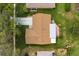 Birds-eye view of home showing roof, driveway, and back patio with manicured lawn at 2958 Macalpin N Dr, Palm Harbor, FL 34684