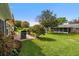 A spacious backyard with lush green grass and a brick paver patio for outdoor enjoyment at 2958 Macalpin N Dr, Palm Harbor, FL 34684