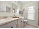 Bright bathroom features double vanity, neutral color palette, framed art, and natural light at 2958 Macalpin N Dr, Palm Harbor, FL 34684