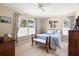 Comfortable bedroom with bright windows, wood floors, and neutral decor at 2958 Macalpin N Dr, Palm Harbor, FL 34684