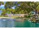 Welcome to Highland Lakes! Community entrance with beautiful landscaping, a waterfall, and a tranquil pond at 2958 Macalpin N Dr, Palm Harbor, FL 34684