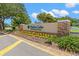 Inviting entrance to Highland Lakes, an active adult golf community, showcases lush landscaping at 2958 Macalpin N Dr, Palm Harbor, FL 34684