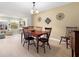 Dining room with wood table and chairs, wood flooring, and view into sitting room at 2958 Macalpin N Dr, Palm Harbor, FL 34684