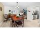 Inviting dining room with wood table and chairs, wood flooring and views into the kitchen at 2958 Macalpin N Dr, Palm Harbor, FL 34684