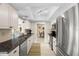 Bright kitchen with stainless steel appliances, granite countertops, and light wooden floors at 2958 Macalpin N Dr, Palm Harbor, FL 34684