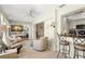 Spacious living room with lots of seating, natural light, and a kitchen bar area at 2958 Macalpin N Dr, Palm Harbor, FL 34684