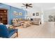 Spacious living room boasting light-colored wood floors, neutral-toned sofas, and large windows at 2958 Macalpin N Dr, Palm Harbor, FL 34684