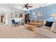 Cozy living room featuring light-colored wood floors, bright blue accent wall, and comfortable seating at 2958 Macalpin N Dr, Palm Harbor, FL 34684