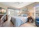 Comfortable bedroom with dresser, night stands and view of a patio area at 2958 Macalpin N Dr, Palm Harbor, FL 34684