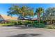 Main entrance of building with covered walkway and lush landscaping at 2958 Macalpin N Dr, Palm Harbor, FL 34684