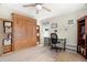 Well lit office featuring hardwood floors, built in shelves, and a murphy bed at 2958 Macalpin N Dr, Palm Harbor, FL 34684