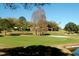 Scenic view of a well-manicured putting green, perfect for practicing your short game at 2958 Macalpin N Dr, Palm Harbor, FL 34684