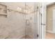 Walk-in shower boasts a tile surround, glass door, and mosaic accent border at 2958 Macalpin N Dr, Palm Harbor, FL 34684