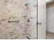 Tiled shower with a handheld showerhead, grab bar, and built-in shelf at 2958 Macalpin N Dr, Palm Harbor, FL 34684