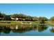 Picturesque water view reflecting nearby homes and a landscaped green at 2958 Macalpin N Dr, Palm Harbor, FL 34684