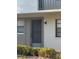 The front of the unit features a secure screen door and updated lighting fixture at 3046 Eastland Blvd # J106, Clearwater, FL 33761