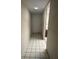 Hallway with neutral walls, tile flooring, and lighting at 3046 Eastland Blvd # J106, Clearwater, FL 33761
