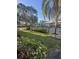 Community pool area surrounded by tropical landscaping and fencing at 3046 Eastland Blvd # J106, Clearwater, FL 33761