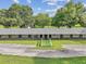 Equestrian barn with multiple stalls and green pastures offering ample space for horses and livestock at 3327 Grove Pl, Land O Lakes, FL 34639