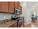 Well-equipped kitchen featuring stainless steel appliances and granite countertops at 3327 Grove Pl, Land O Lakes, FL 34639