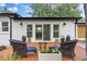 Inviting backyard deck featuring comfortable seating, a small table, and a view of the lush surroundings at 3520 Poplar Ne St, St Petersburg, FL 33704