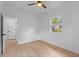 White bedroom with wood floors, a window, a ceiling fan, and a closet at 3520 Poplar Ne St, St Petersburg, FL 33704