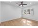 Light and bright bedroom offers wood floors, neutral paint, a ceiling fan and a window at 3520 Poplar Ne St, St Petersburg, FL 33704