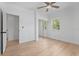 Bedroom featuring neutral walls, wood floors, ceiling fan, closet, and natural light from a window at 3520 Poplar Ne St, St Petersburg, FL 33704
