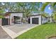 Inviting home showcasing well-manicured lawn, modern garage with unique door, and a charming walkway at 3520 Poplar Ne St, St Petersburg, FL 33704
