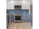 Charming kitchen featuring stainless steel appliances, modern tile backsplash, and stylish two-tone cabinetry at 3520 Poplar Ne St, St Petersburg, FL 33704
