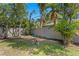 Landscaped backyard featuring a privacy fence, lush trees, and a hammock for outdoor relaxation at 3822 W Euclid Ave, Tampa, FL 33629