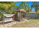 Charming backyard shed with porch swing and stone pathway in a lush, private backyard setting at 3822 W Euclid Ave, Tampa, FL 33629