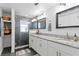 Modern bathroom featuring a double vanity with granite countertop, a glass-enclosed shower, and modern fixtures at 3822 W Euclid Ave, Tampa, FL 33629